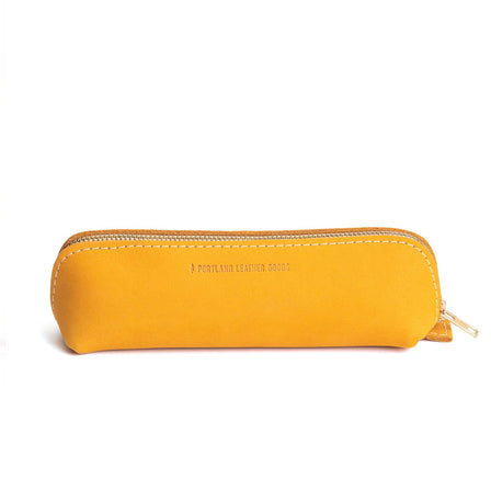 All Color: Turmeric | Leather pouch with curved seams and top zipper